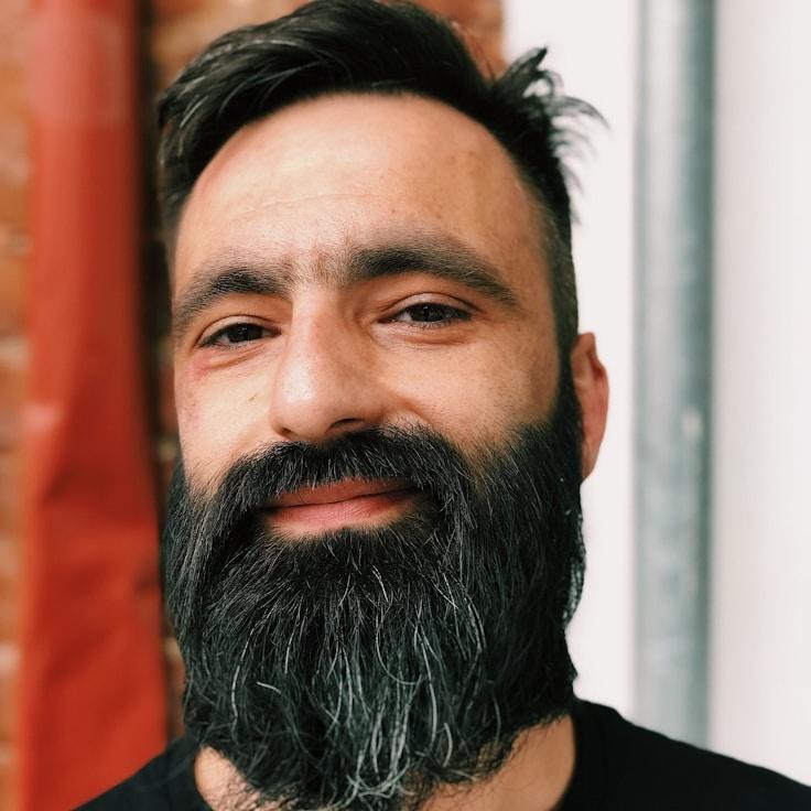 Kaveri Mehta, Lead Design Curator at RippleMeadowVale, reviewing corporate floral arrangements